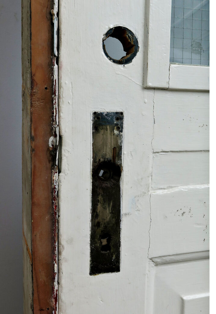 Skoledør med fyldninger og glas.